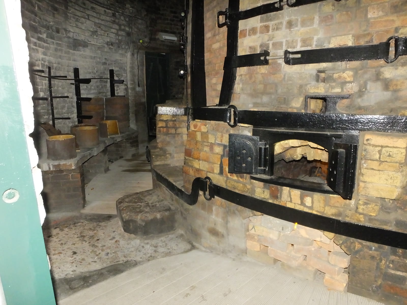 Documentary still: a brick kiln room with iron bands and saggars. Stock photograph — not the Potters Guild of Baltimore.
