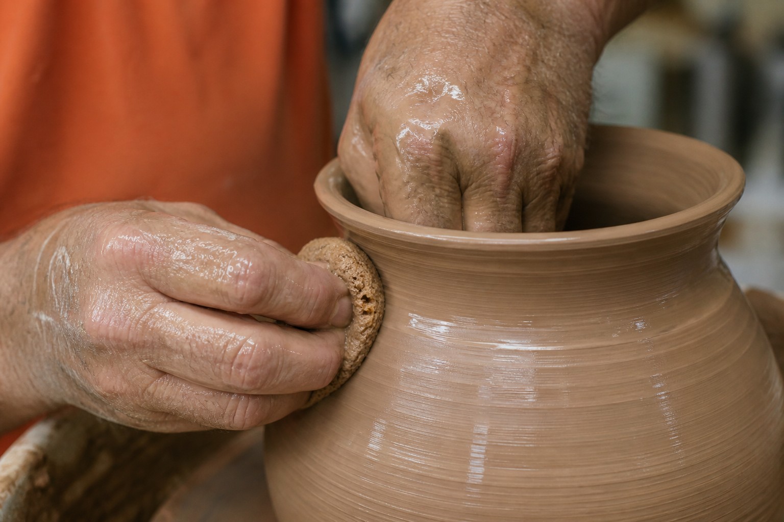 First-party documentary photo: potter’s hands throwing on a wheel at Ceramic League of Miami.