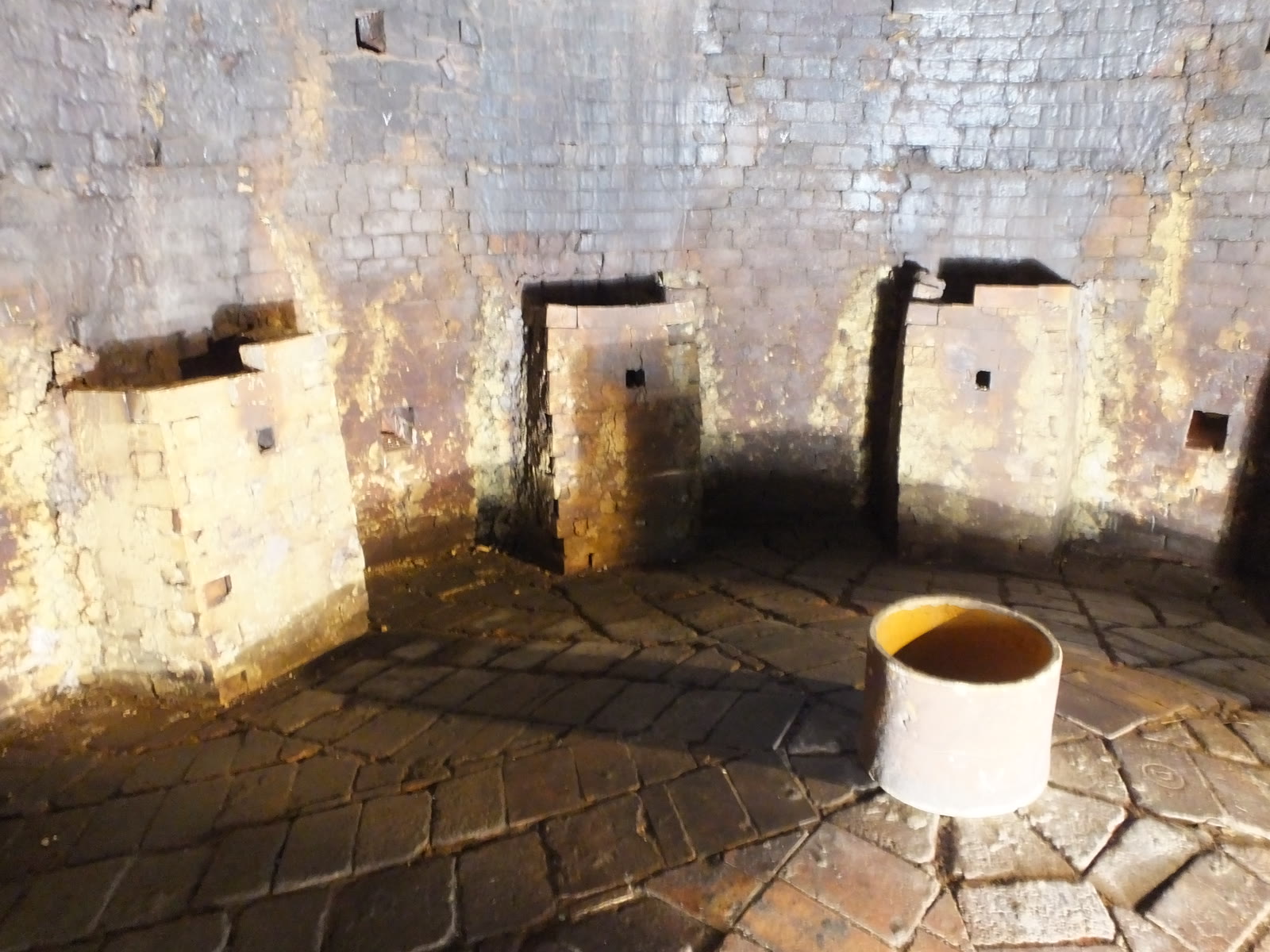 Documentary still: a brick kiln room with iron bands and saggars. Stock photograph — not the Potters Guild of Baltimore.