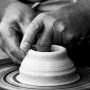 Black-and-white photo of hands throwing a pot on a wheel, from the Sanctuary Pottery Studio website (first-party).